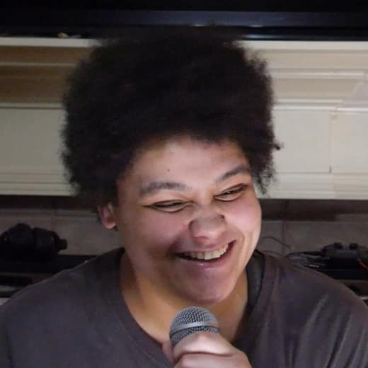 Ashley Huff laughing into a microphone