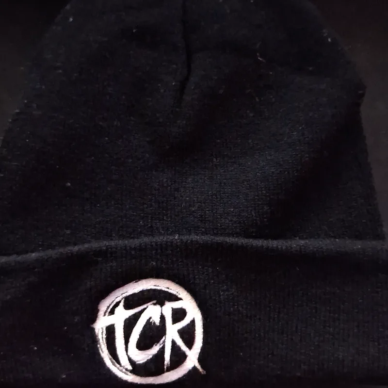Black knit beanie with the TCR seal embroidered on the cuff